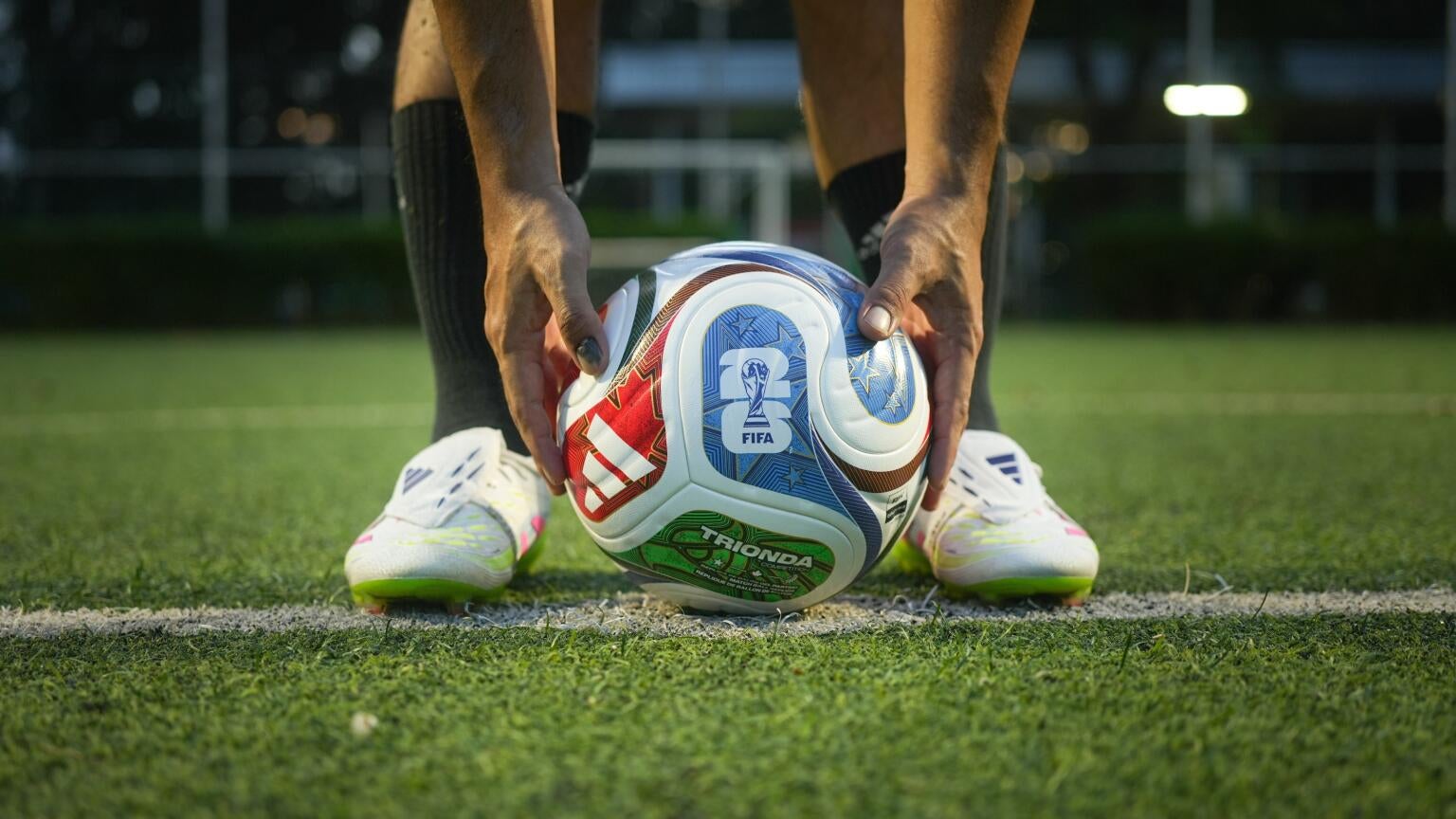 A player holding a World Cup ball, and how to save watching World Cup games with DIRECTV.