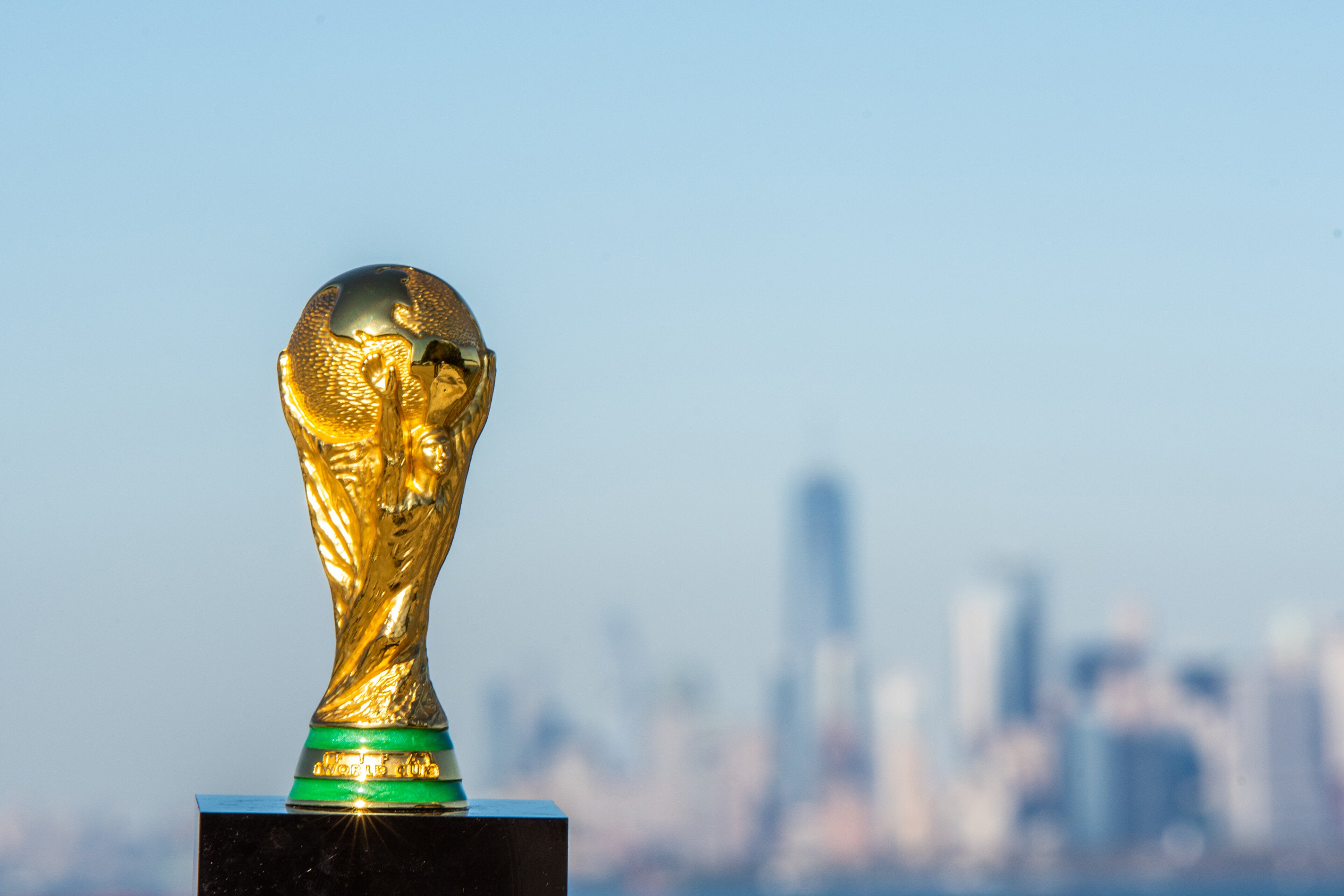 The FIFA World Cup trophy against the backdrop of New York City's skyline