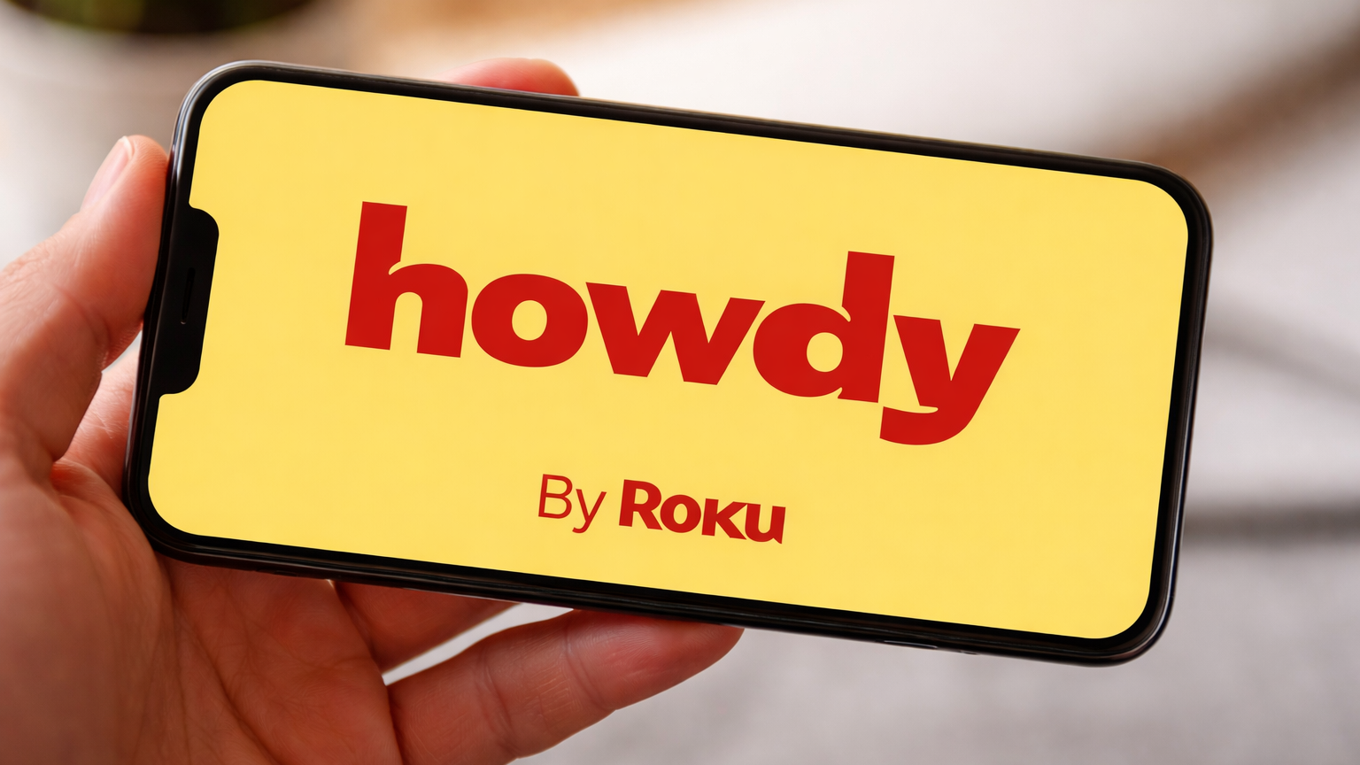 The Howdy streaming service logo on a phone screen.