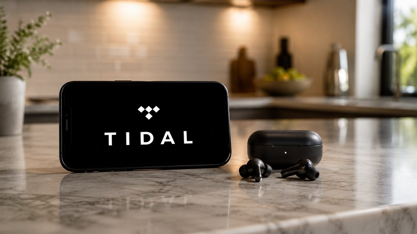The Tidal logo on a phone screen with earbuds.