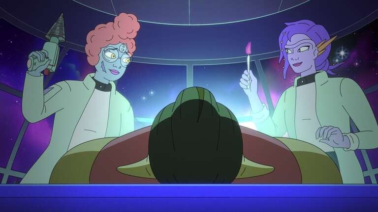 A still from an animated series featuring two aliens--- one with green skin, curly red hair, and three eyes, and the other with purple skin and purple hair. They look at each other smiling while standing over an unidentifable patient laying on an operating table.